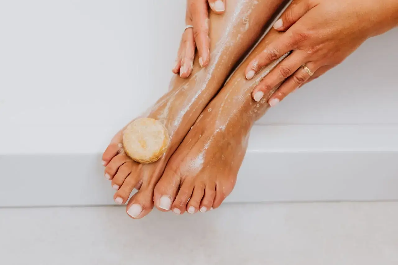 A pair of feet with pastel nail polish.