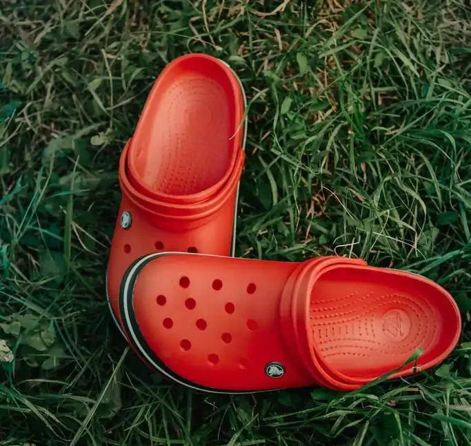 Red Crocs Lying on the Grass